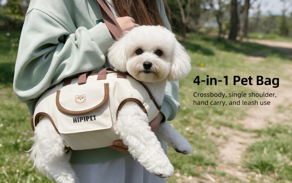 A person holding a cream pet bag against their chest, a small white dog leaning out, on a sunny path
